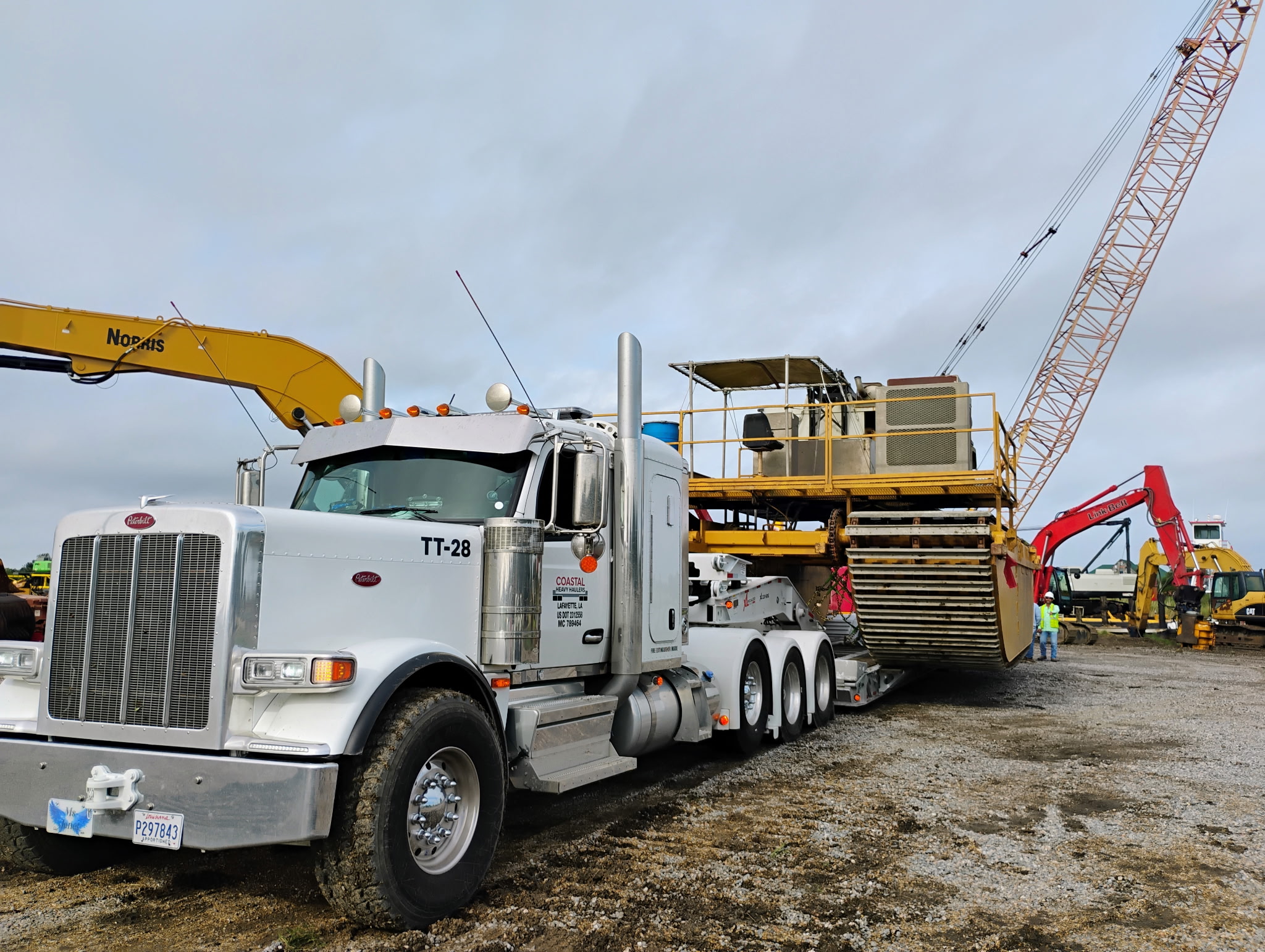 Coastal truck transporting a crawler crane